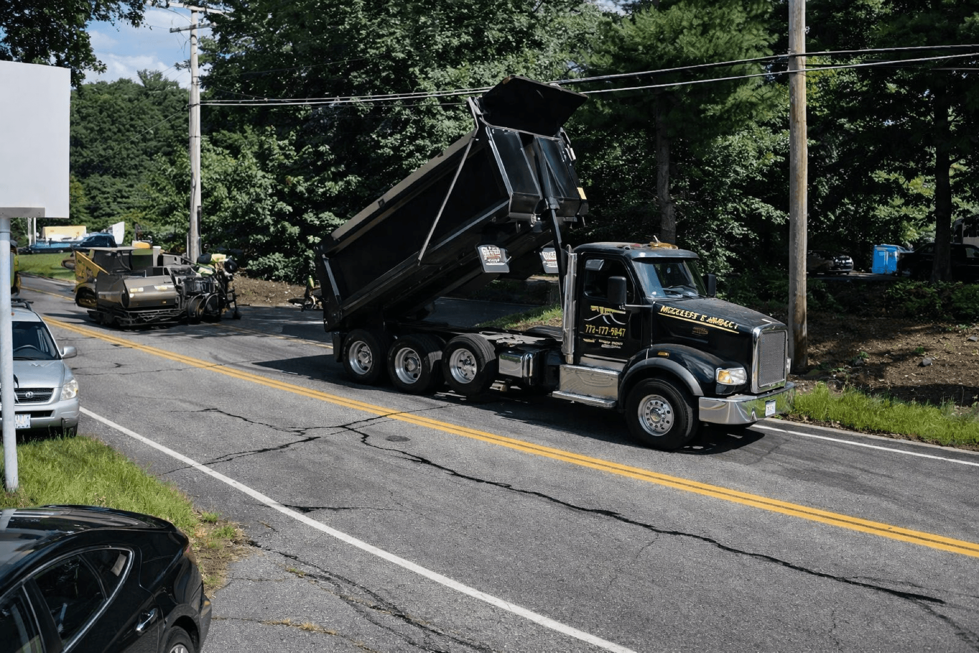 Branded dump truck parked at a road paving project