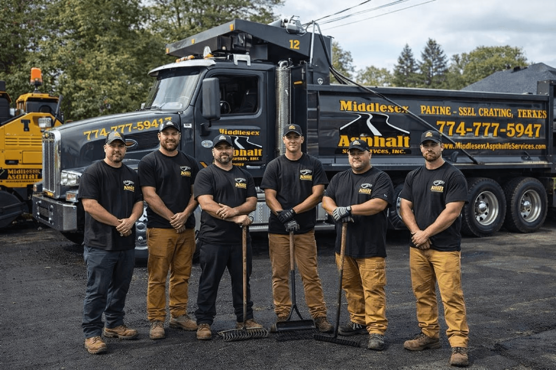Paving crew standing in front of a company work truck